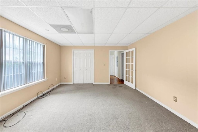 1735 Silver Way, Lithia Springs, GA 30122 - unfurnished bedroom featuring carpet floors, a drop ceiling, and a closet