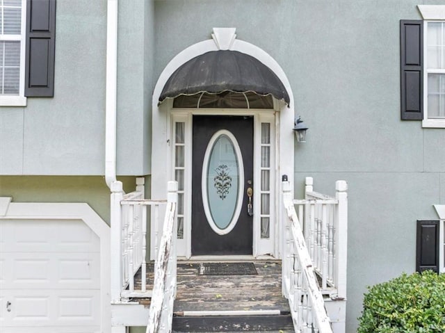 1735 Silver Way, Lithia Springs, GA 30122 - view of exterior entry featuring stucco siding and a garage
