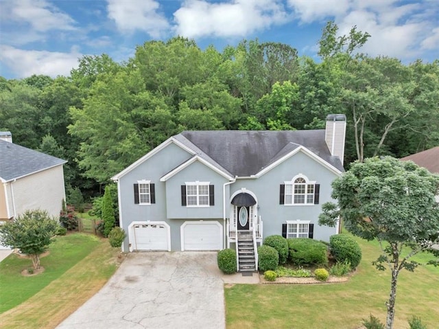 1735 Silver Way, Lithia Springs, GA 30122 - raised ranch with a chimney, driveway, a front yard, a garage, and stucco siding