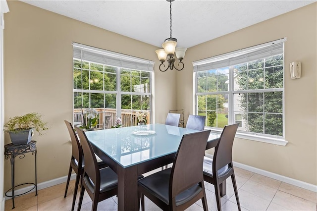 185 Fox Run, Loganville, GA 30052 - dining room featuring a chandelier, plenty of natural light, and light tile patterned floors