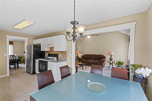 185 Fox Run, Loganville, GA 30052 - dining area with a chandelier and light tile patterned flooring