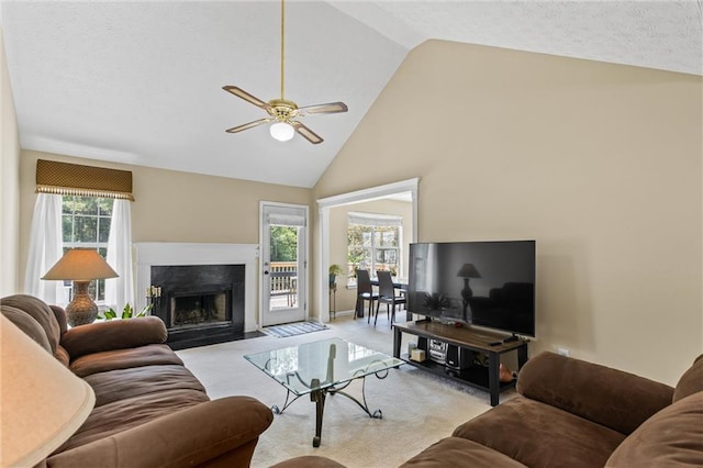 185 Fox Run, Loganville, GA 30052 - carpeted living area featuring a ceiling fan, high vaulted ceiling, and a fireplace with flush hearth