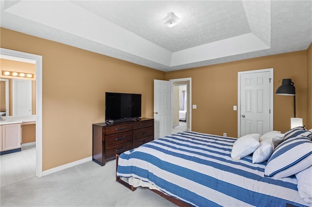 185 Fox Run, Loganville, GA 30052 - bedroom with a raised ceiling, light carpet, a textured ceiling, and ensuite bathroom