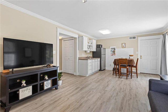 185 Fox Run, Loganville, GA 30052 - living room featuring crown molding and light wood finished floors