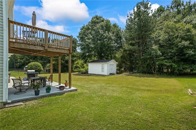 185 Fox Run, Loganville, GA 30052 - view of grassy yard with a deck, a patio, a shed, and view of scattered trees