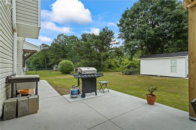 185 Fox Run, Loganville, GA 30052 - view of patio featuring a grill and an outbuilding