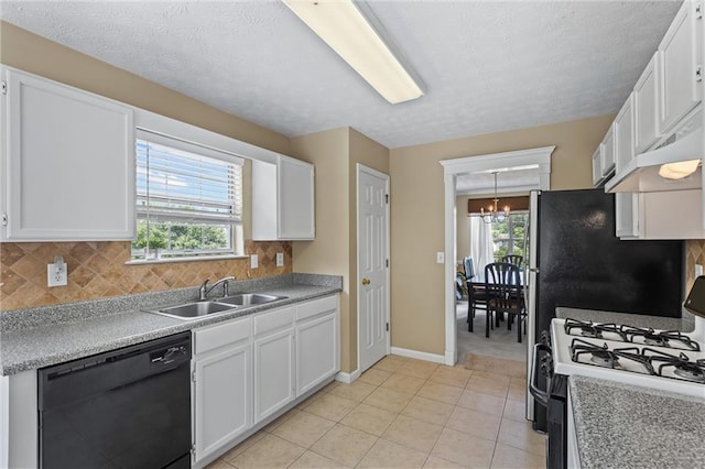 185 Fox Run, Loganville, GA 30052 - kitchen with dishwasher, gas range oven, a chandelier, white cabinets, and tasteful backsplash