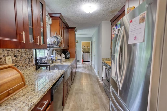 1638 River Trce, Auburn, GA 30011 - kitchen with stainless steel appliances, light wood finished floors, a textured ceiling, backsplash, and light stone counters