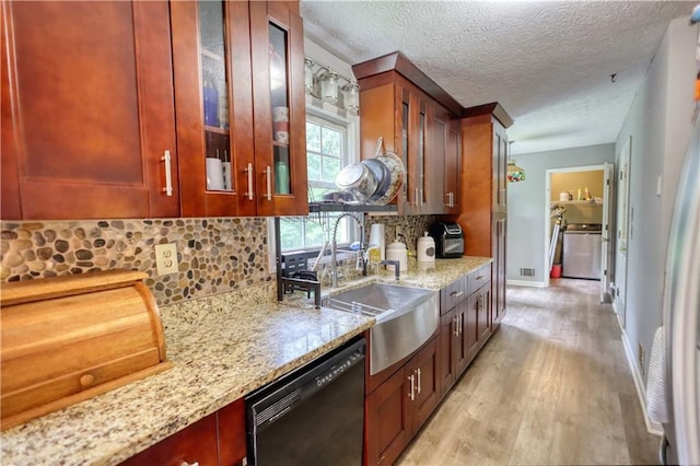 1638 River Trce, Auburn, GA 30011 - kitchen with black dishwasher, light stone countertops, light wood-type flooring, tasteful backsplash, and glass insert cabinets