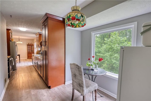1638 River Trce, Auburn, GA 30011 - dining space with a textured ceiling, light wood-type flooring, baseboards, and a chandelier