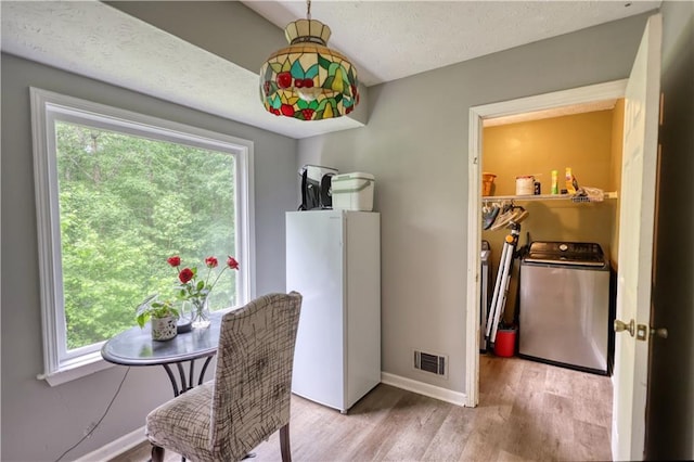 1638 River Trce, Auburn, GA 30011 - dining room featuring wood finished floors, baseboards, a textured ceiling, and washing machine and dryer