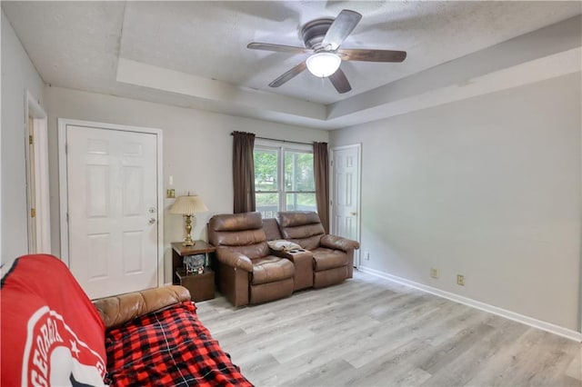 1638 River Trce, Auburn, GA 30011 - living room with a raised ceiling, light wood-type flooring, a ceiling fan, baseboards, and a textured ceiling