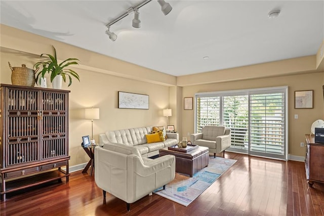 living room with hardwood / wood-style floors and track lighting