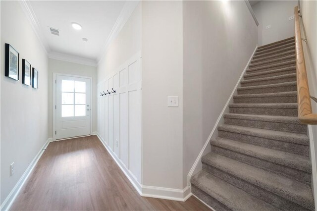 interior space featuring crown molding and hardwood / wood-style floors