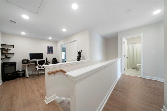 hallway with hardwood / wood-style flooring