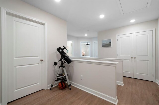 corridor with light hardwood / wood-style floors