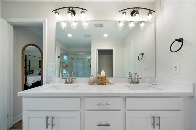 bathroom featuring vanity and an enclosed shower