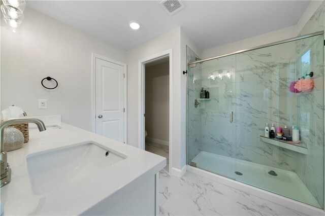 bathroom with toilet, an enclosed shower, and vanity