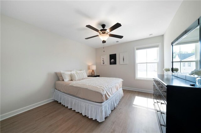 bedroom featuring hardwood / wood-style floors and ceiling fan