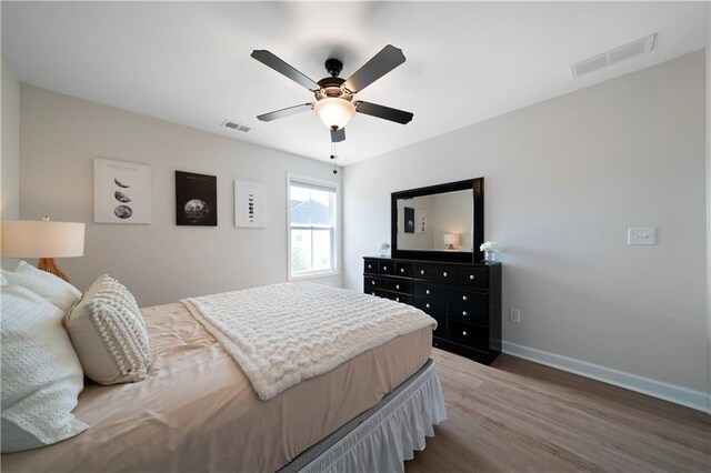 bedroom with wood-type flooring and ceiling fan