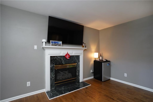 7185 Hartsfield Pl, Suwanee, GA 30024 - living area with wood finished floors, baseboards, and a high end fireplace