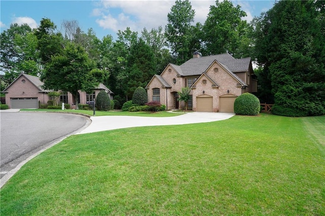 7185 Hartsfield Pl, Suwanee, GA 30024 - view of front of home featuring asphalt driveway, a front yard, brick siding, and a garage
