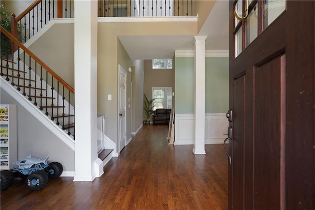7185 Hartsfield Pl, Suwanee, GA 30024 - entrance foyer with a high ceiling, decorative columns, dark wood finished floors, and stairs