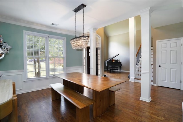 7185 Hartsfield Pl, Suwanee, GA 30024 - dining space featuring decorative columns, stairs, wainscoting, ornamental molding, and dark wood finished floors
