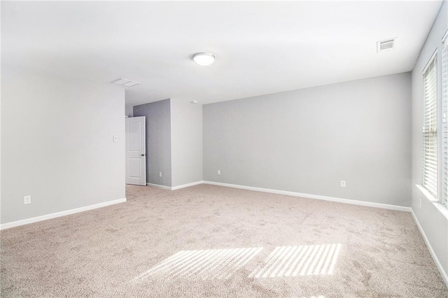 unfurnished room featuring carpet flooring, healthy amount of natural light, and baseboards