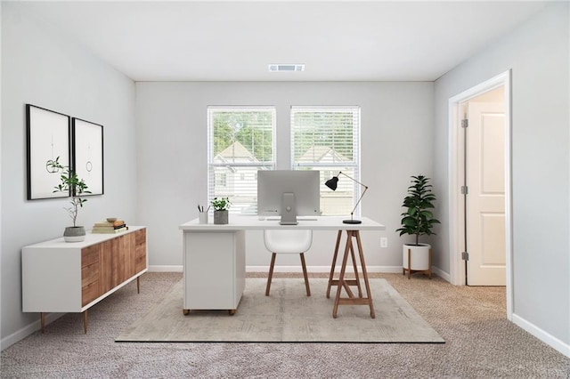 office area with light carpet and baseboards