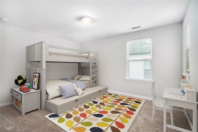 bedroom with light colored carpet and baseboards