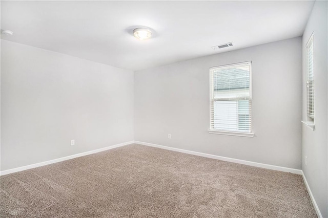 spare room with carpet floors and baseboards