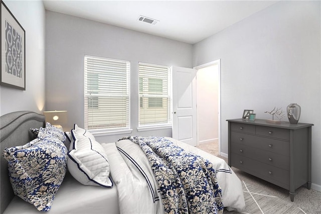 bedroom with light carpet and baseboards