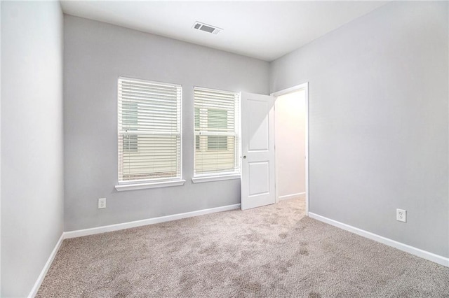 carpeted empty room with baseboards