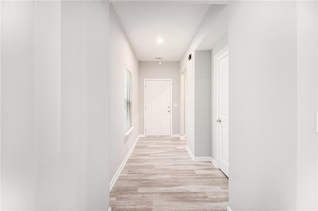 hallway with light wood-style flooring, baseboards, and recessed lighting