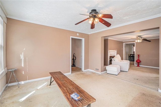 interior space with a textured ceiling, ornamental molding, and baseboards