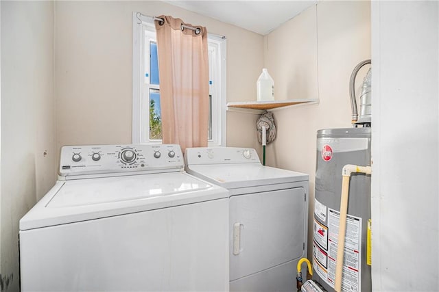 laundry room with laundry area, washer and clothes dryer, and gas water heater