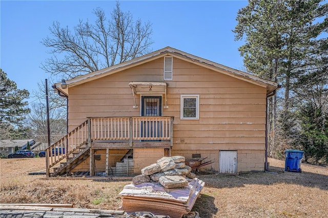 view of front of property featuring crawl space and stairs