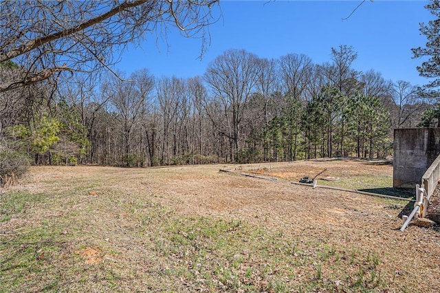 view of yard with a view of trees