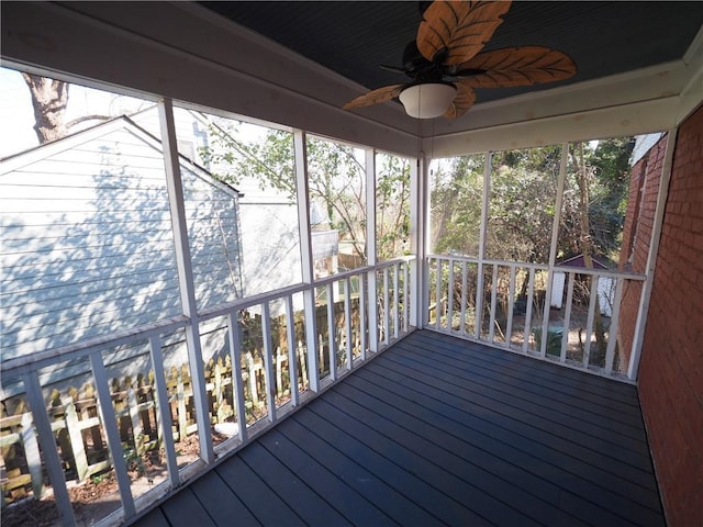 unfurnished sunroom featuring ceiling fan