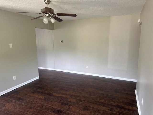 unfurnished room featuring baseboards, a ceiling fan, a textured ceiling, and wood finished floors