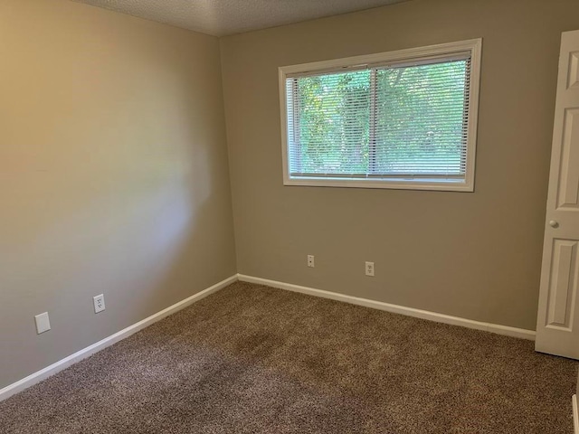 unfurnished room featuring baseboards and carpet flooring