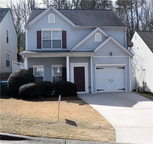 235 Woodland Way, Canton, GA 30114 - traditional home with concrete driveway, an attached garage, and a front lawn