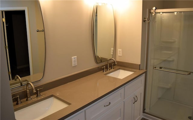 235 Woodland Way, Canton, GA 30114 - bathroom featuring a shower stall, double vanity, and a sink