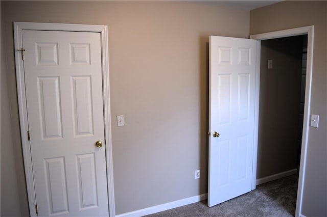 235 Woodland Way, Canton, GA 30114 - unfurnished bedroom with baseboards and dark carpet