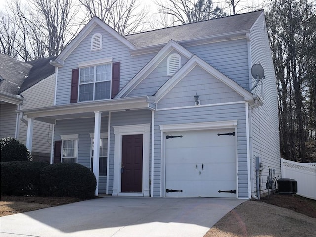 view of front of home with concrete driveway, fence, and central air condition unit