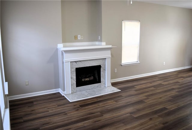 235 Woodland Way, Canton, GA 30114 - unfurnished living room featuring a high end fireplace, baseboards, and dark wood-style flooring