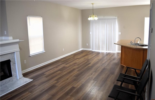 235 Woodland Way, Canton, GA 30114 - living room featuring a notable chandelier, dark wood-type flooring, baseboards, and a premium fireplace