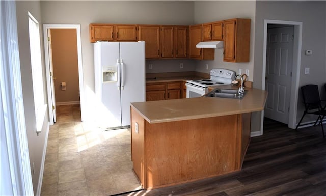235 Woodland Way, Canton, GA 30114 - kitchen with under cabinet range hood, light countertops, a peninsula, white appliances, and a sink