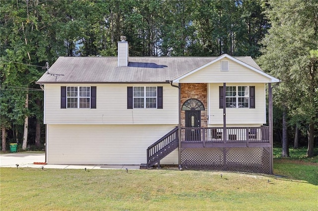 raised ranch with a chimney and a front yard